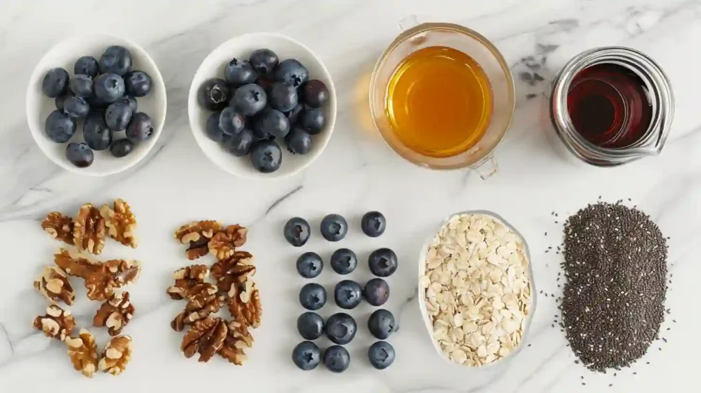 Fresh ingredients for blueberry oatmeal, including rolled oats, blueberries, milk, honey, and cinnamon displayed on a kitchen counter.