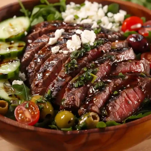Mediterranean steak bowl with tender steak, fresh veggies, Kalamata olives, feta cheese, and extra virgin olive oil.